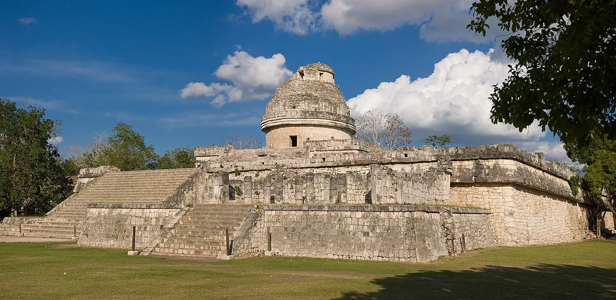 El Caracol observatory dome among trees inside the Chichen Itza ruins in Yucatan, Mexico